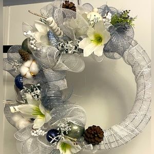 This is a.beautiful winter handmade wreath. Blues, white and silver